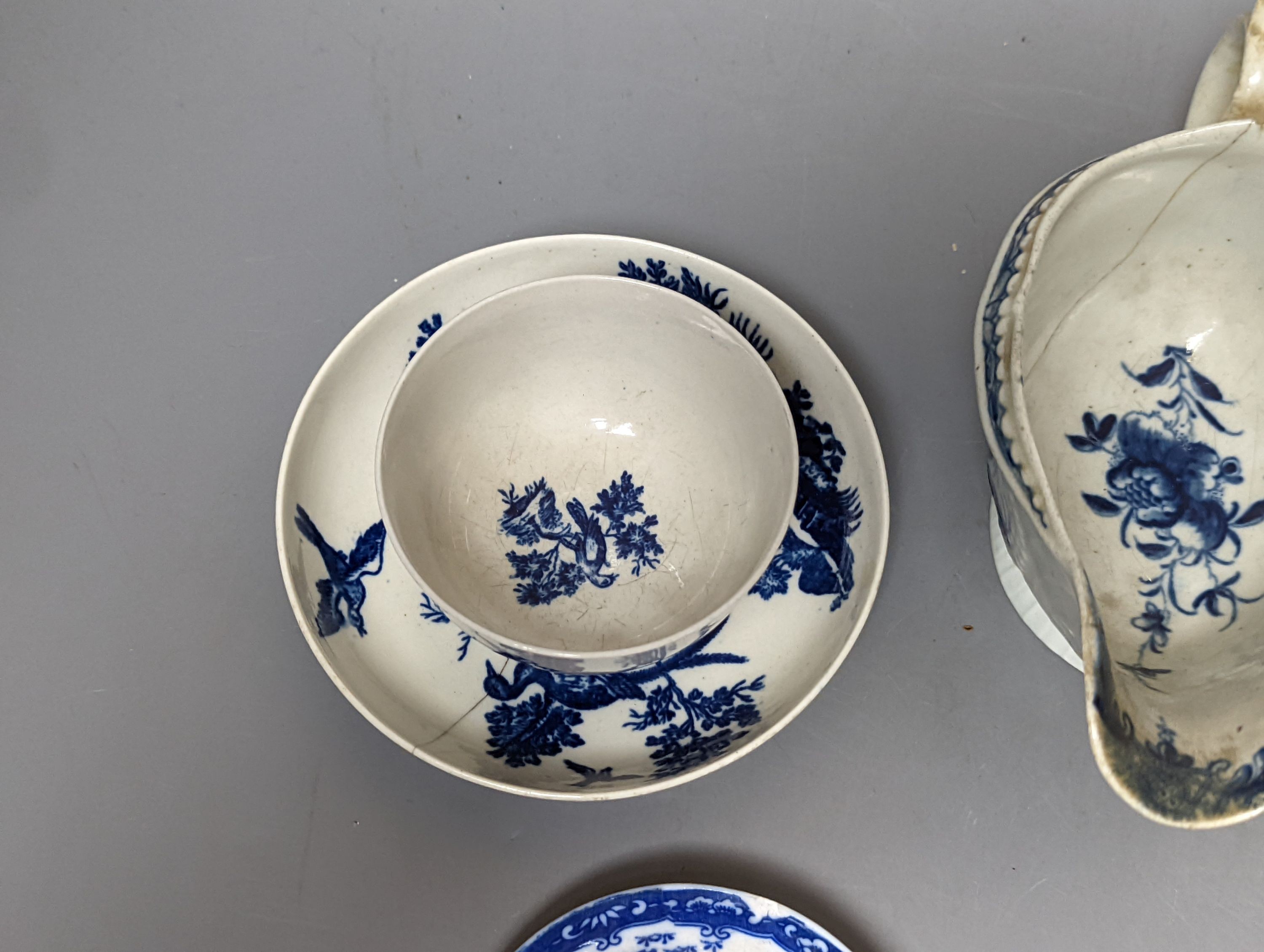 A Worcester blue and white sauceboat, two tea bowls and saucers, late 18th century and a Japanese single saucer. (7)